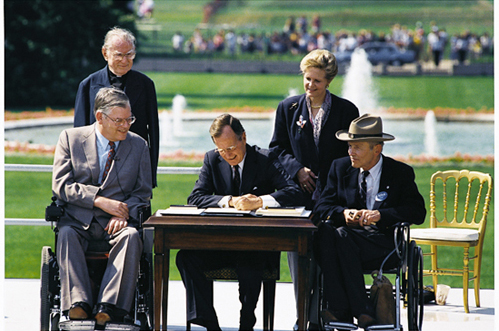 President George H.W. Bush signs the Americans with Disabilities Act on July 26, 1990