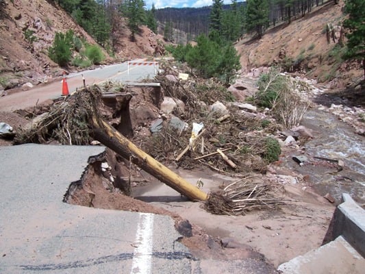 In June of 2006 flood debris clogged a concrete box culvert. The water eroded out the highway in its search for a new flow path.