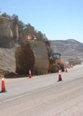 Crews preparing to blast a large boulder to clear the highway. thumbnail image