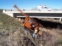 Getting the rig down to into position for a bridge foundation boring. thumbnail image