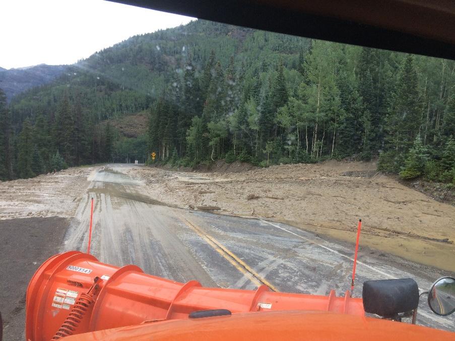 Snowplow clears mud and debris from US 550