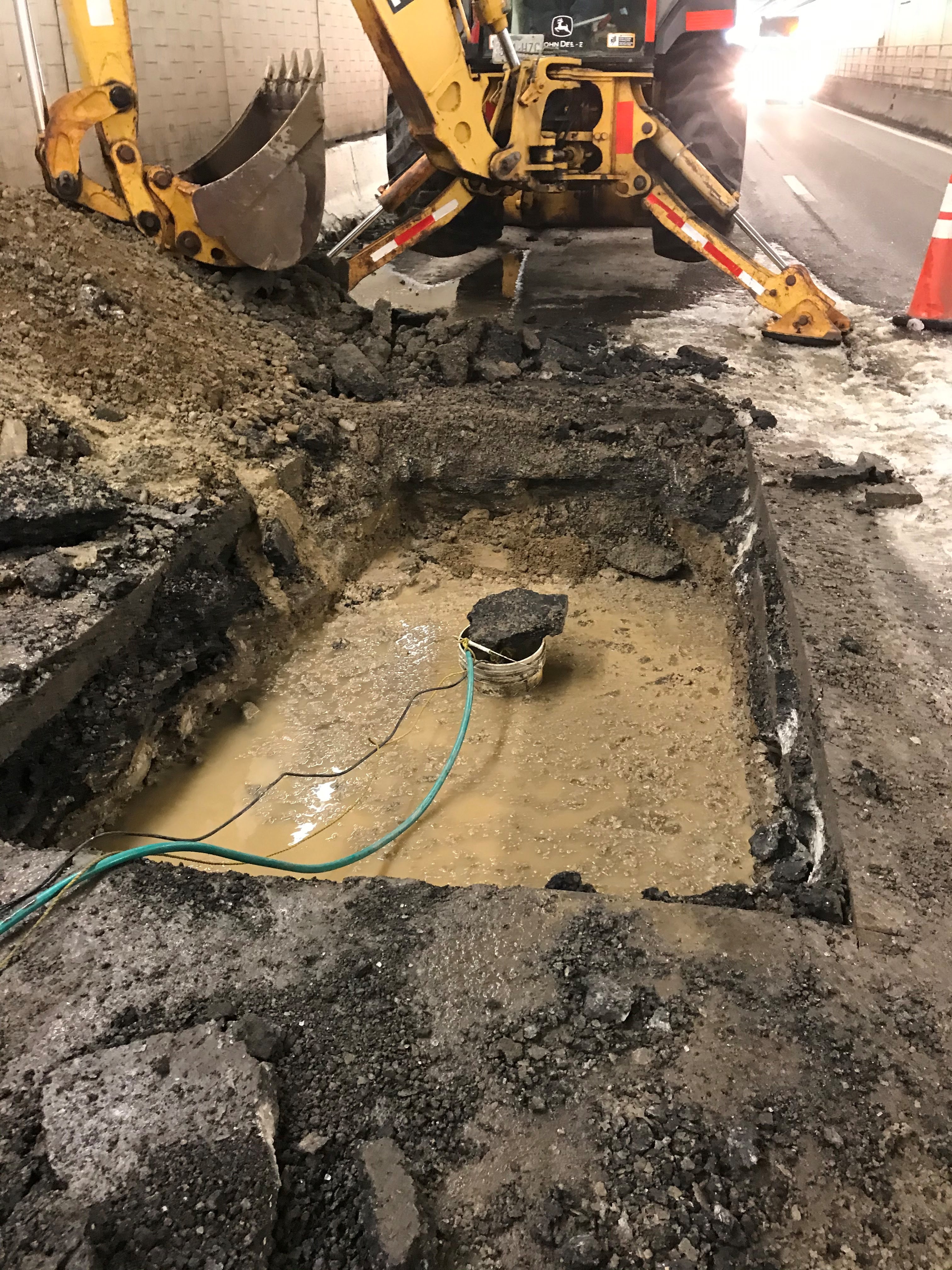 Tractor working to repair the road in the Eisenhower Johnson Memorial Tunnel detail image