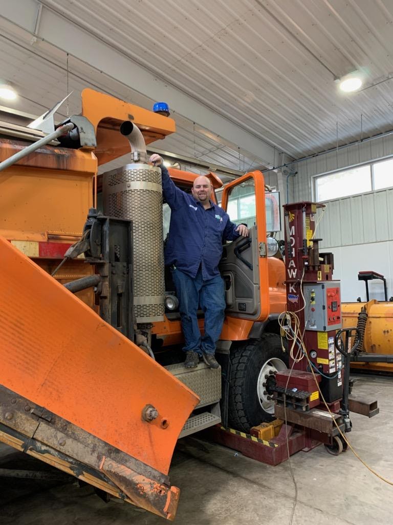 CDOT maintenance team member prepping a snowplow for the weekend storm detail image