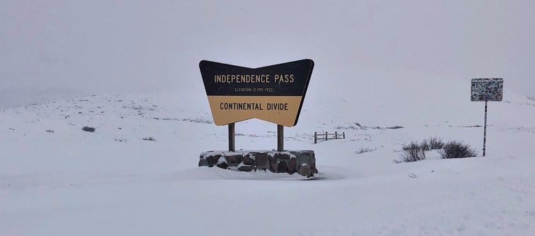 Snow and Independence Pass sign