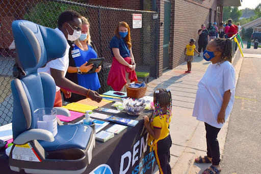 Families participate in Car Seat Safety booth detail image