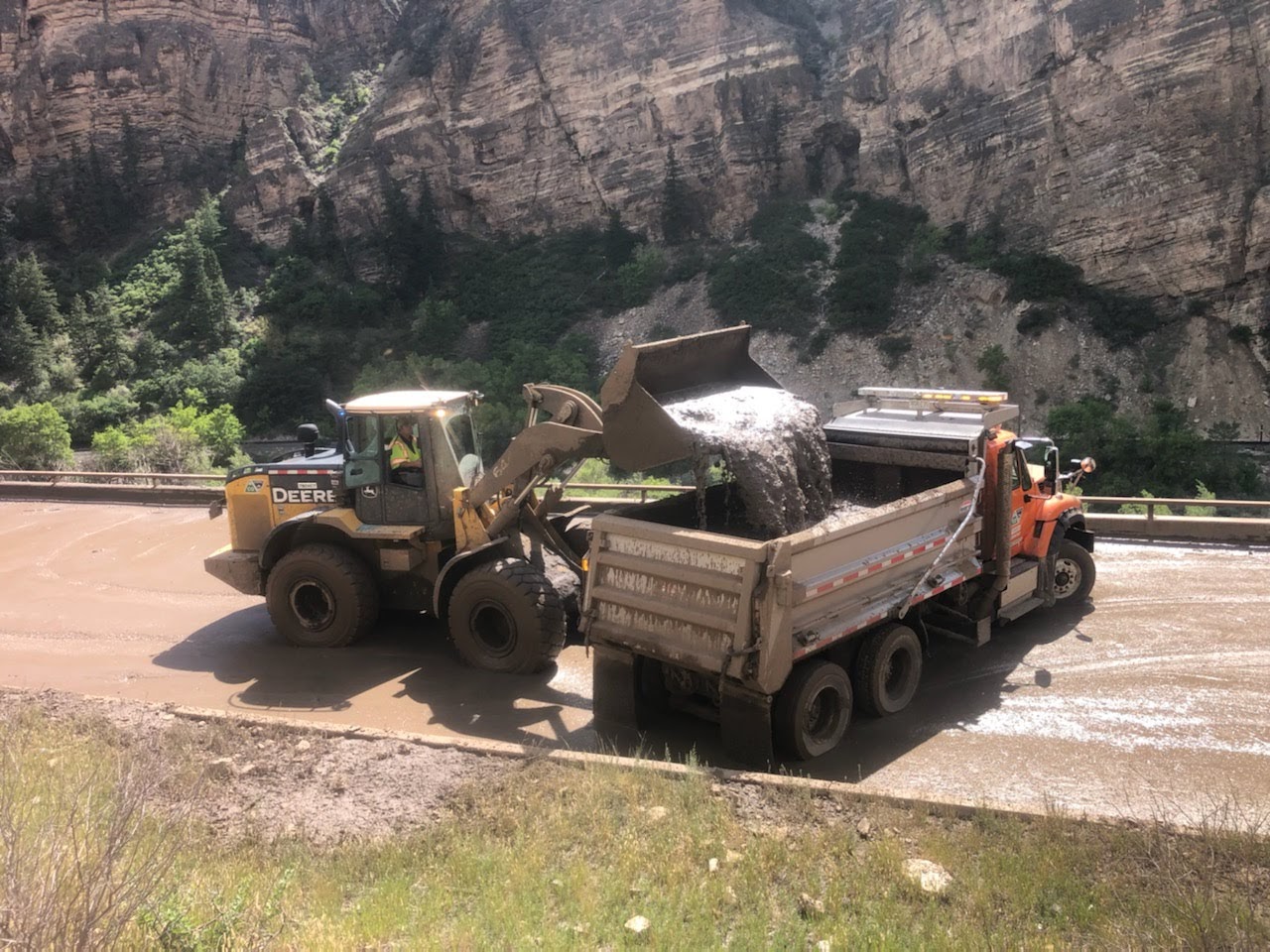 Glenwood Canyon mudslide tractor dumping mud during clean up detail image