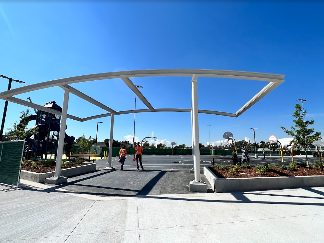 Crew workers standing on new Swansea Elementary School playground detail image