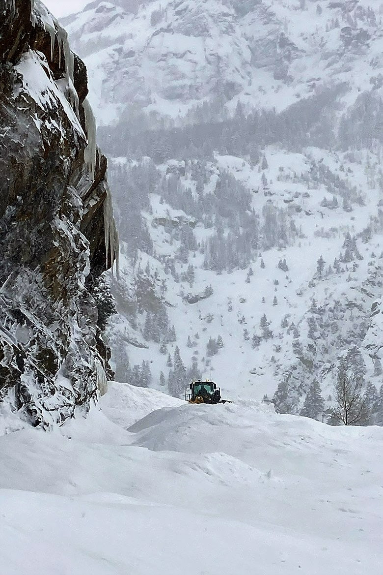 Plow tractor lost in a snowy avalanche detail image