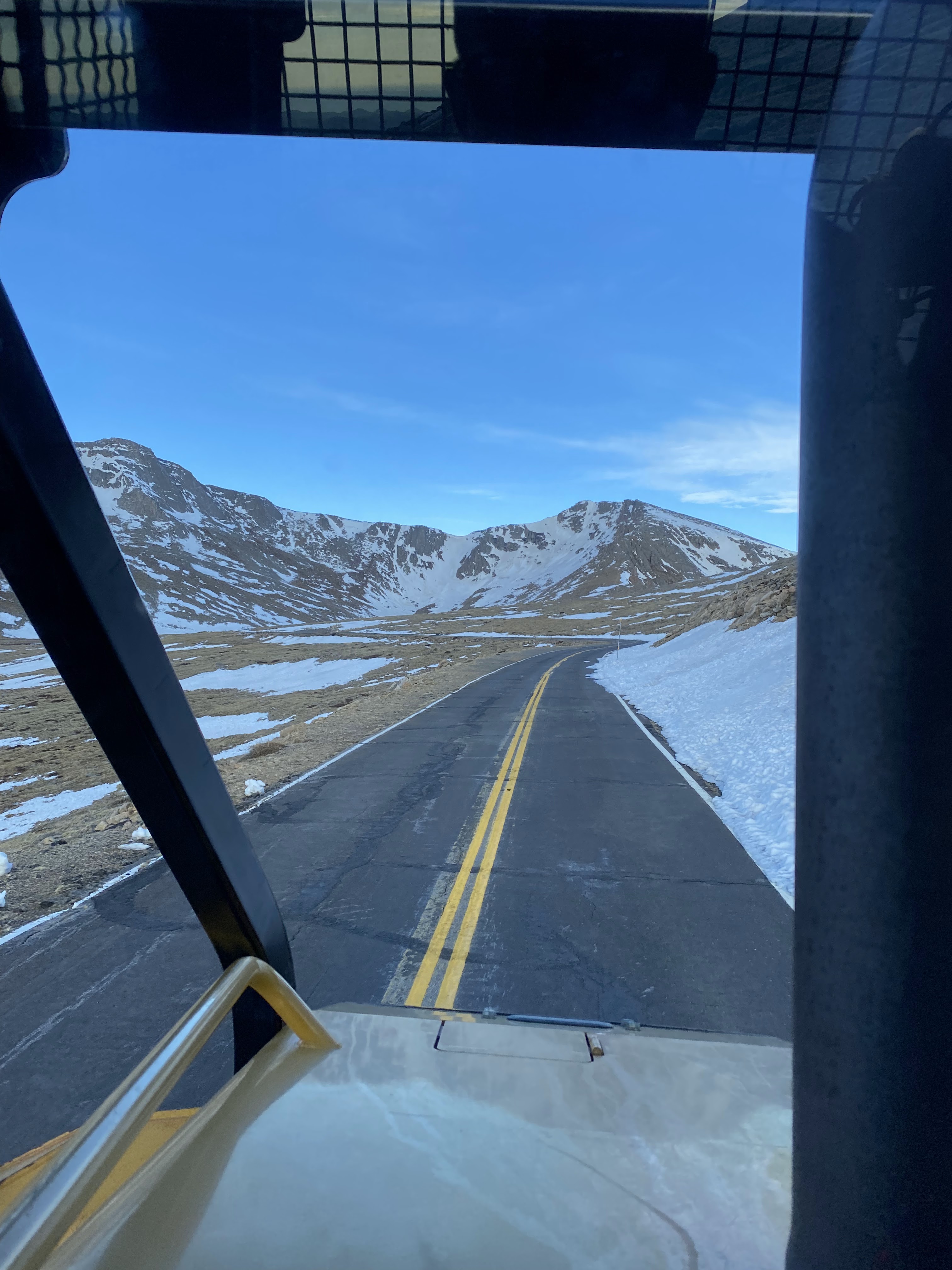 View of Mount Evans and cleared road from the cab of the tractor detail image