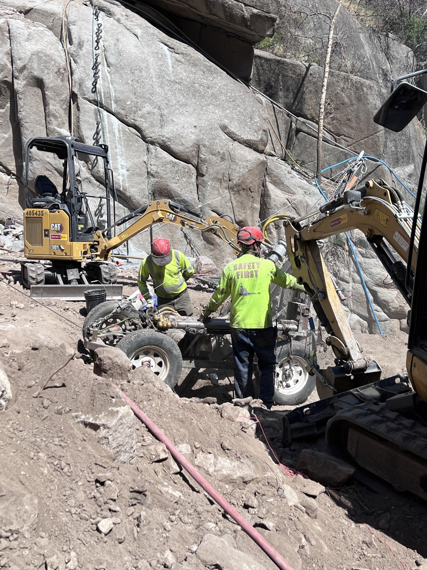 Crews preparing equipment to haul up the side of a rockface.jpg detail image