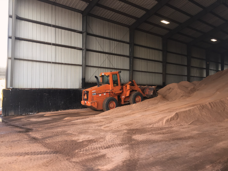 Crews stacking winter materials solid de-icers.png detail image