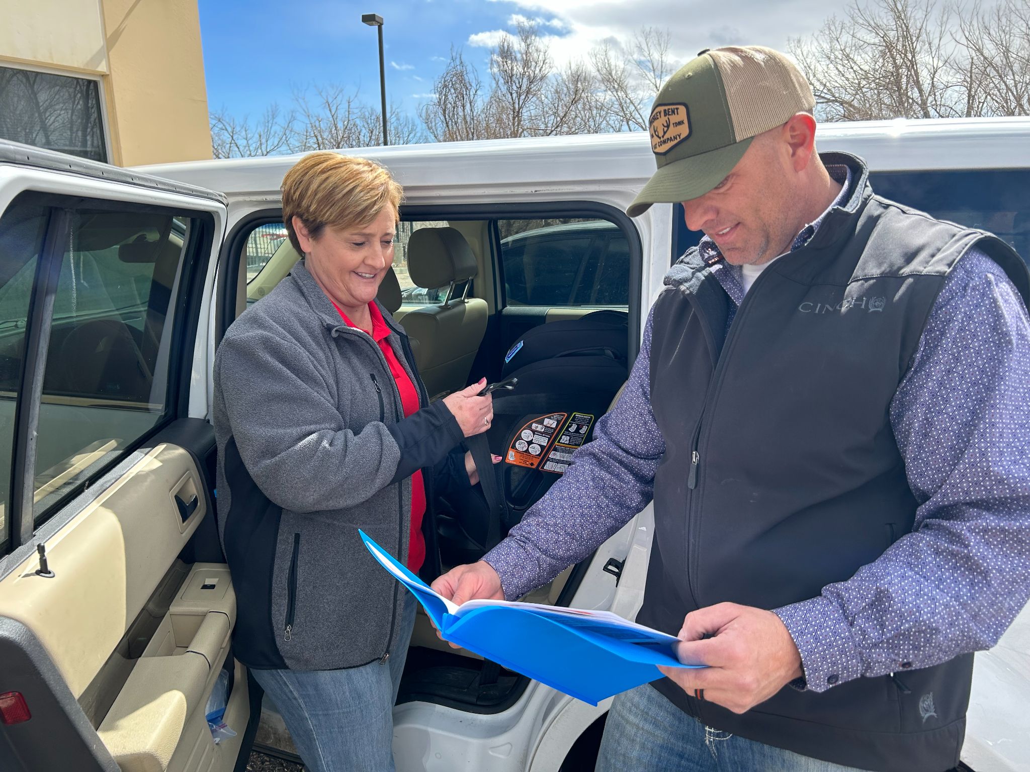 Angel Giffin Colorado State Patrols Child Passenger Safety Training Coordinator and a student from the course stand outside a car.jpeg detail image