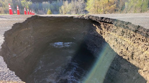 The above photo shows the sinkhole and related damage as of the morning of May 3.