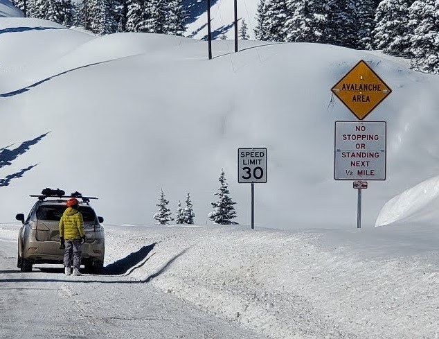 Backcountry users are urged to park in designated pullouts located off of the highway and away from known avalanche areas. This vehicle is parked in a hazardous zone. 