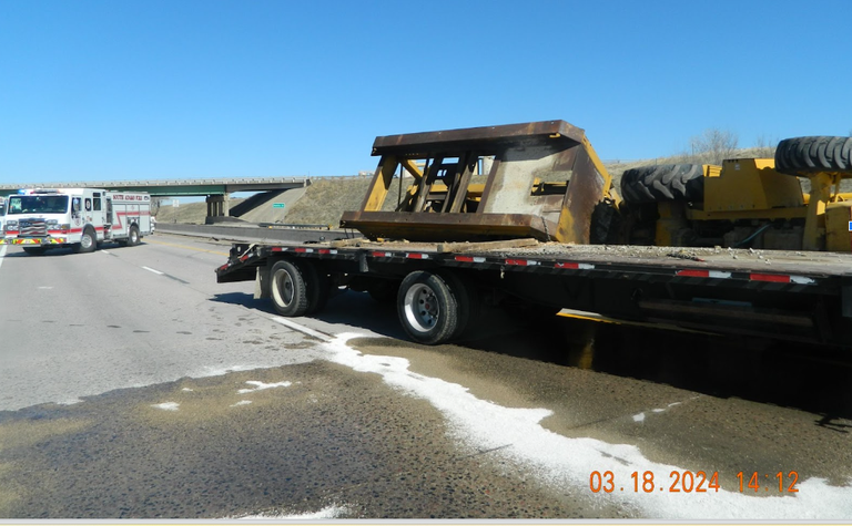 Side view of tractor-trailer rolled over after in struck a bridge over I-76 on 318