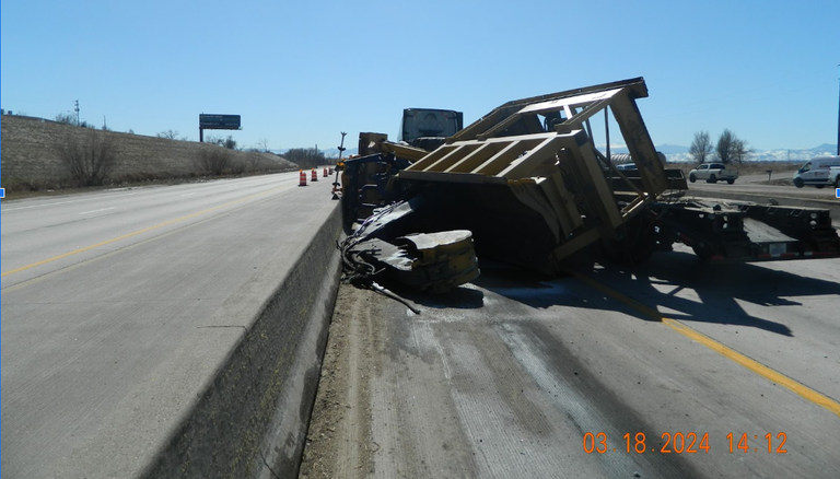 Tractor-trailer after it struck a bridge over I-76 on 318