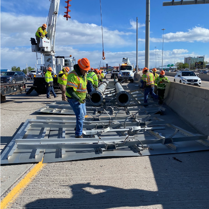 CDOT maintenance crews removing the sign structure from the roadway.