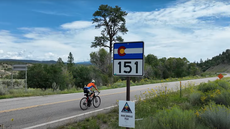 A cyclist riding on Colorado Highway 151 during the 2024 Colorado's Ride Event