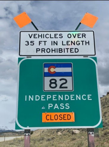 CO 82 Independence Pass road sign, with an orange sign reading "closed" attached