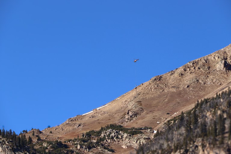Helicopter loading charges on new Wyssen equipment on the east side of the Eisenhower Johnson Memorial Tunnels