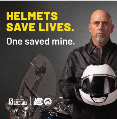 Helmets Save Lives. One saved mine. A man wearing a black leather jacket standing next to a motorcycle holding a white motorcycle helmet. Text on graphic reads “Helmets save lives. One saved mine.”