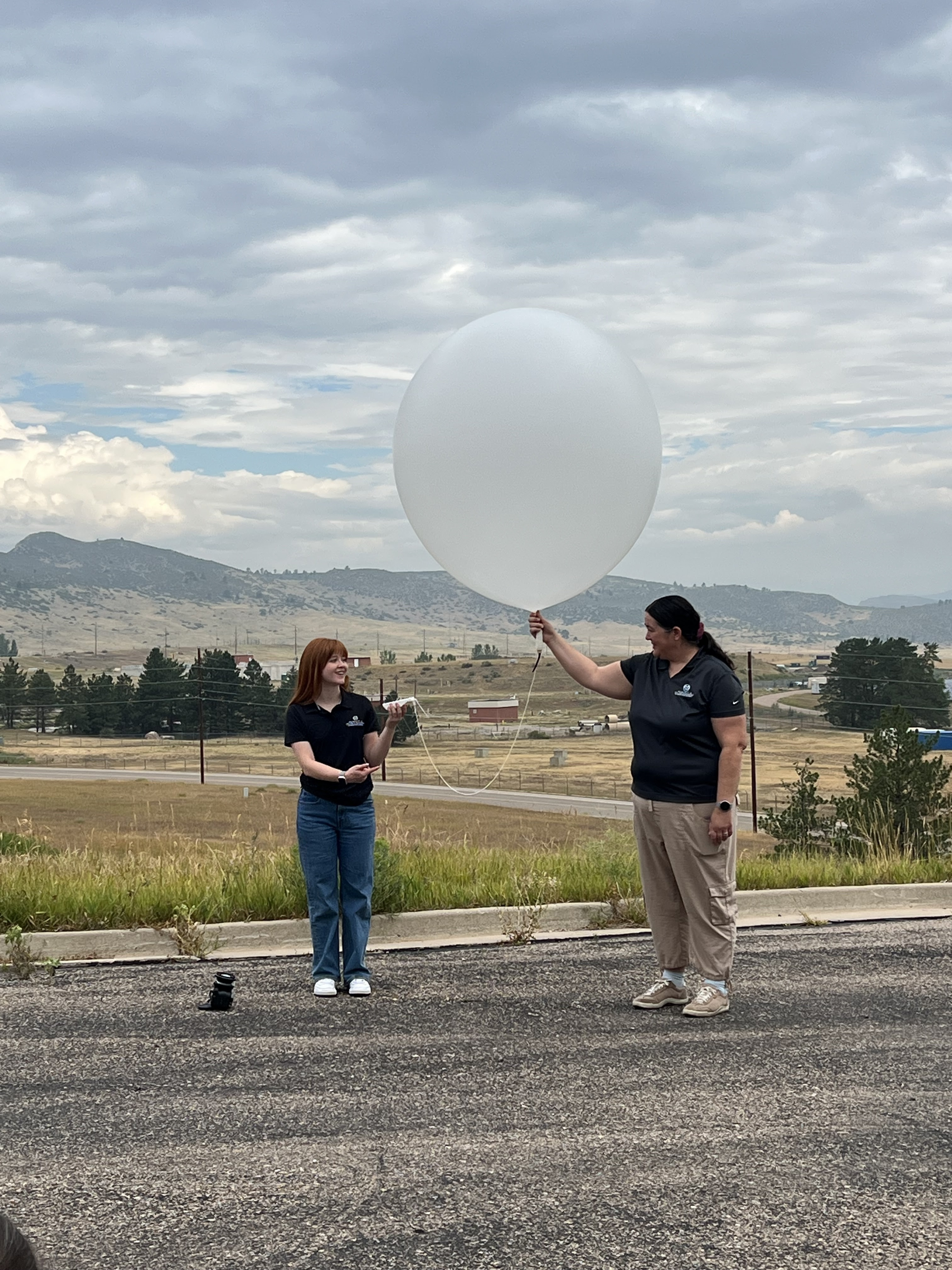 Brenda Dolan and Colorado State University PhD student hold weather balloon.jpg detail image