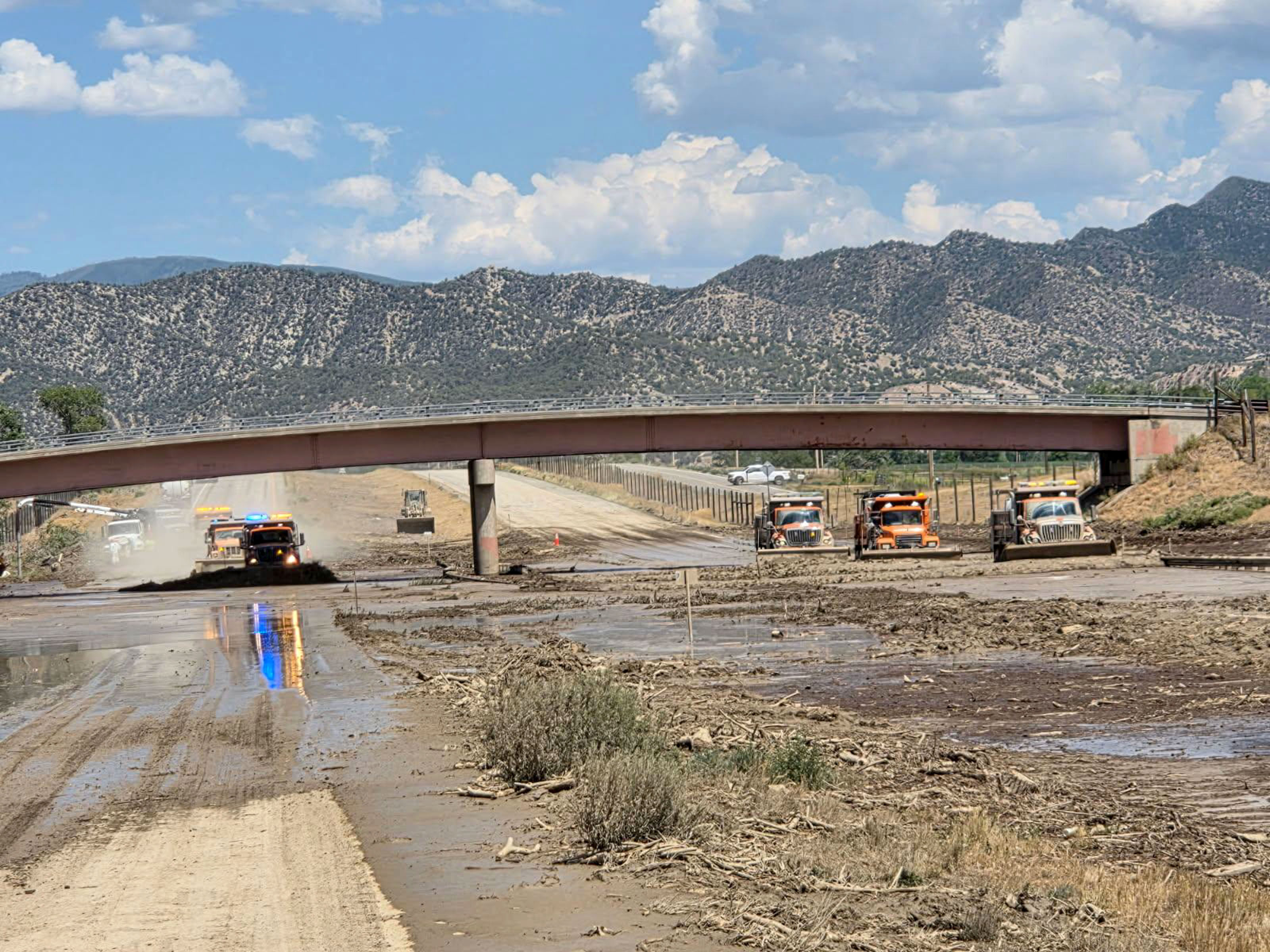 CDOT crews search for buried drains and direct flood water to the uncovered drains.jpg detail image