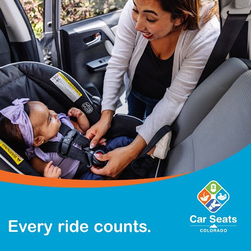 A mother fastens her young child’s rear-facing car seat belt. Text overlay reads “Every ride counts.”
