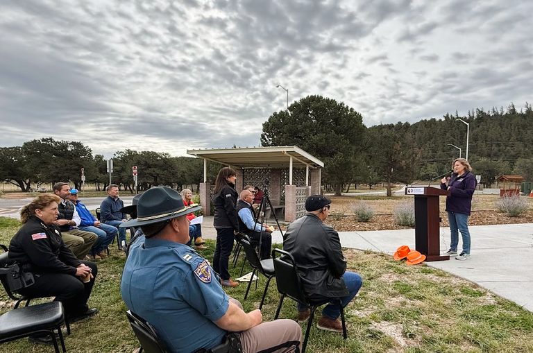 Julie Constan addresses the audience at the Shaw Creek Rest Area ribbon cutting event