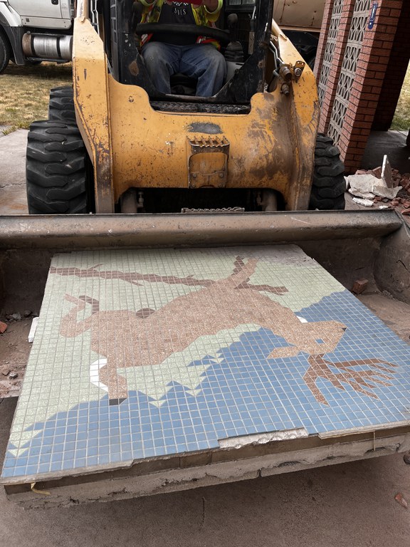 A heavy machinery carefully carried the mosaic-tiled mural of a deer, created in the mid-1960s, was saved from the original building.