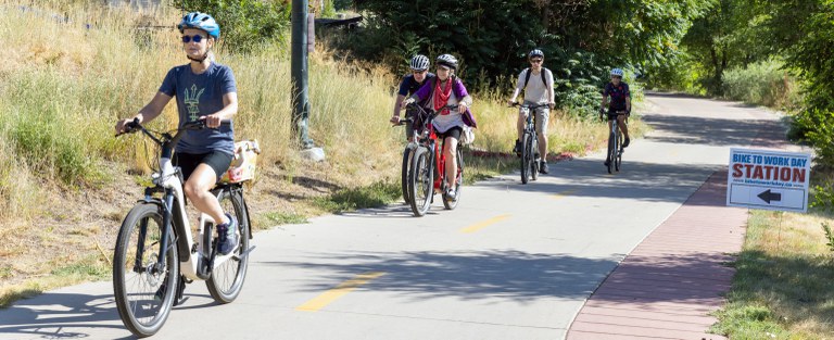 Cyclists Bike Along a Denver Trail on Bike to Work Day Cyclists Bike Along a Denver Trail on Bike to Work Day