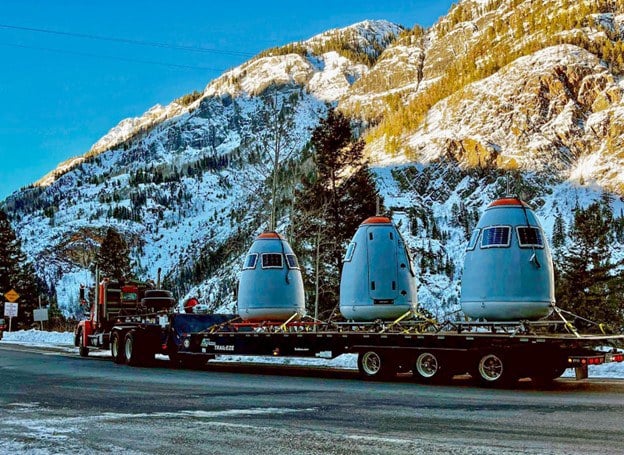 A semi truck delivers remote-controlled Gazex avalanche control units to be installed at the top of avalanche paths on Red Mountain Pass