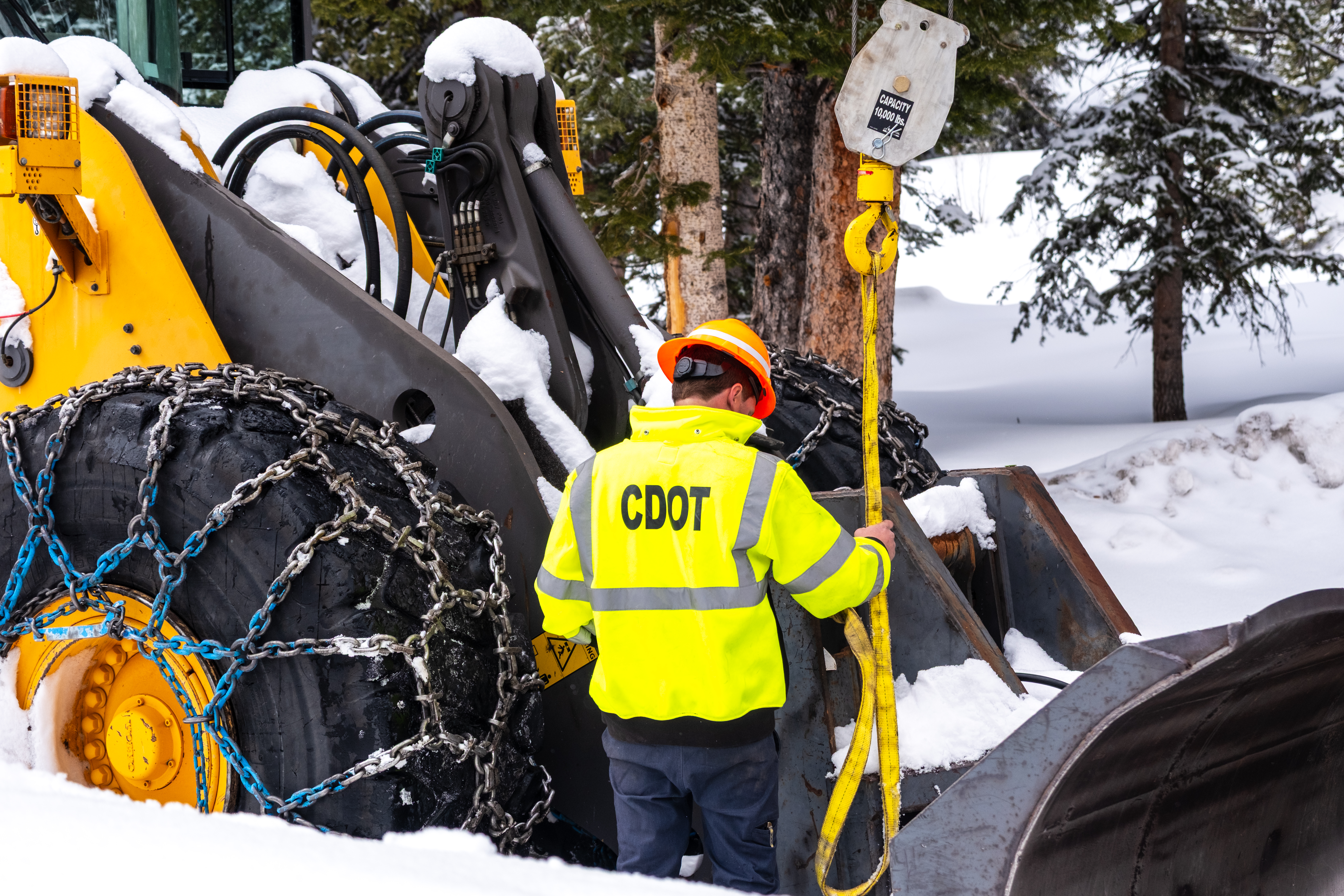 CDOT mechanic Ryan Smith using a tackle truck to repair a plow on Grand Mesa.jpg detail image