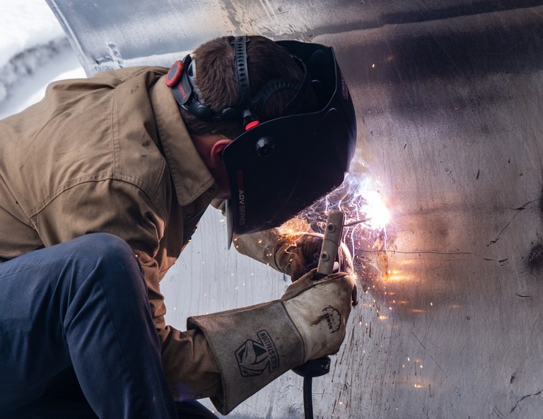CDOT mechanic Ryan Smith repairs a plow blade with welding equipment Ryan Smith, CDOT mechanic, repairs a plow blade with welding equipment.