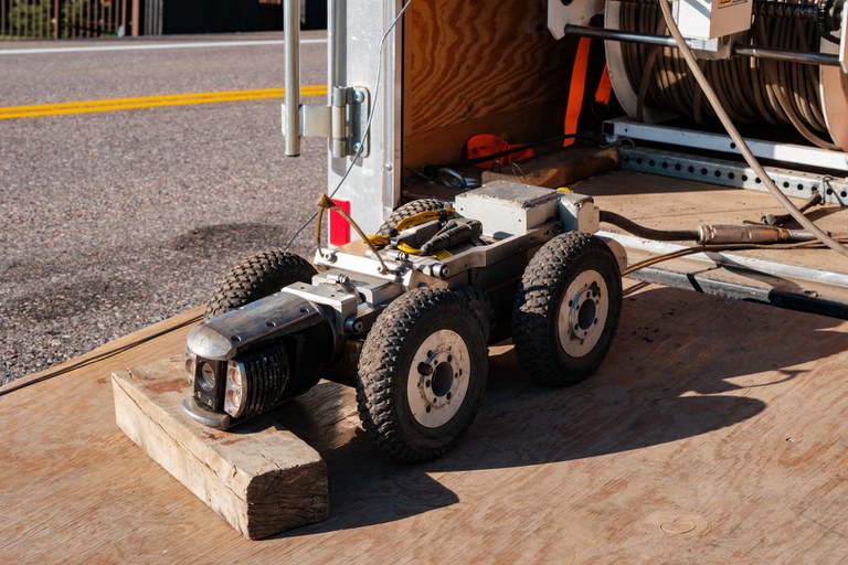 A small remote-controlled vehicle sits on the lowered gate of a trailer in Sedalia, Colorado