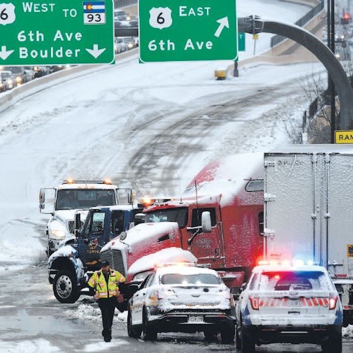 Safety personnel cleaning up a crash on the roadway