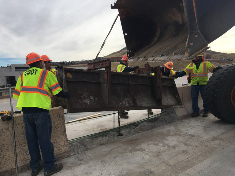 Crews installing a barrier on the road