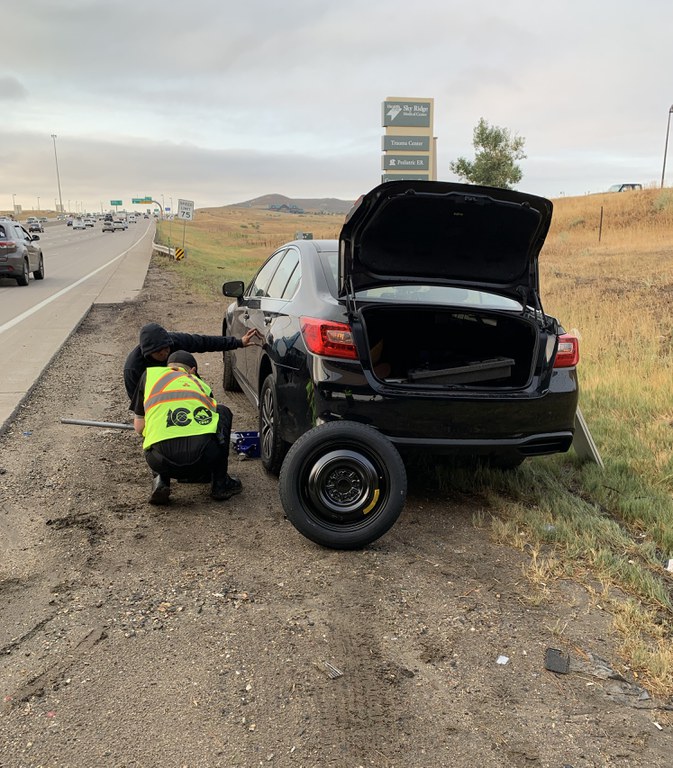 CDOT's Safety Patrol team provides roadside assistance for non-emergency situations, such as flat tires, jump starts or minor mechanical issues. CDOT Safety Patrol crew assisting motorist with a flat tire on the side of a Colorado highway.
