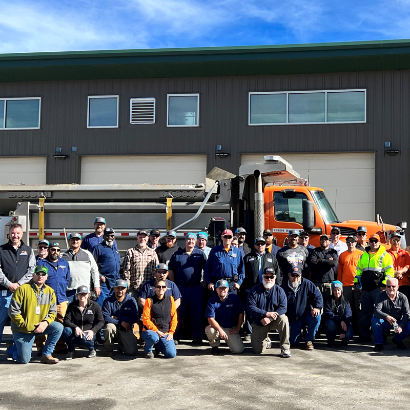 Maintainers in front of a snowplow