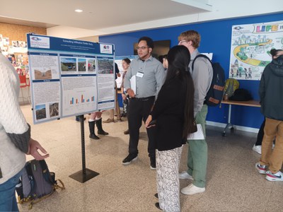 Eric Linkhart presenting research poster to MSU Denver students