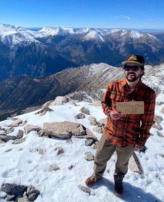 Peter Ferraro Peter Ferraro on the top of a snowy mountain holding a sign that says "Mt. Princeton 14,200 feet".