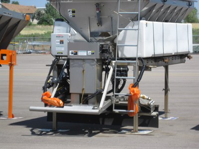 A plow trucks sander unit stored in the yard with the hydraulic hoses bagged to prevent leaks from contaminating stormwater runoff.