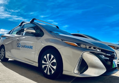 Silver Colorado Car Share sedan with ski racks. 