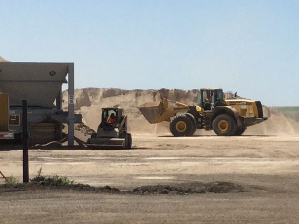 Crews at asphalt paving plant