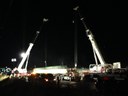 Cranes pick a girder from a truck for placement on piers. thumbnail image