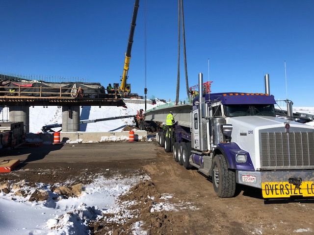 Crews unloading girders for placement northbound bridge detail image