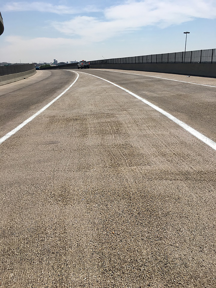 Polyester concrete overlays on bridge from I-70 East to Washington Street ramp, and I-25 south ramp to I-70 east (after). Polyester concrete overlay was placed to waterproof and protect the bridge deck with a durable material (July 2018).