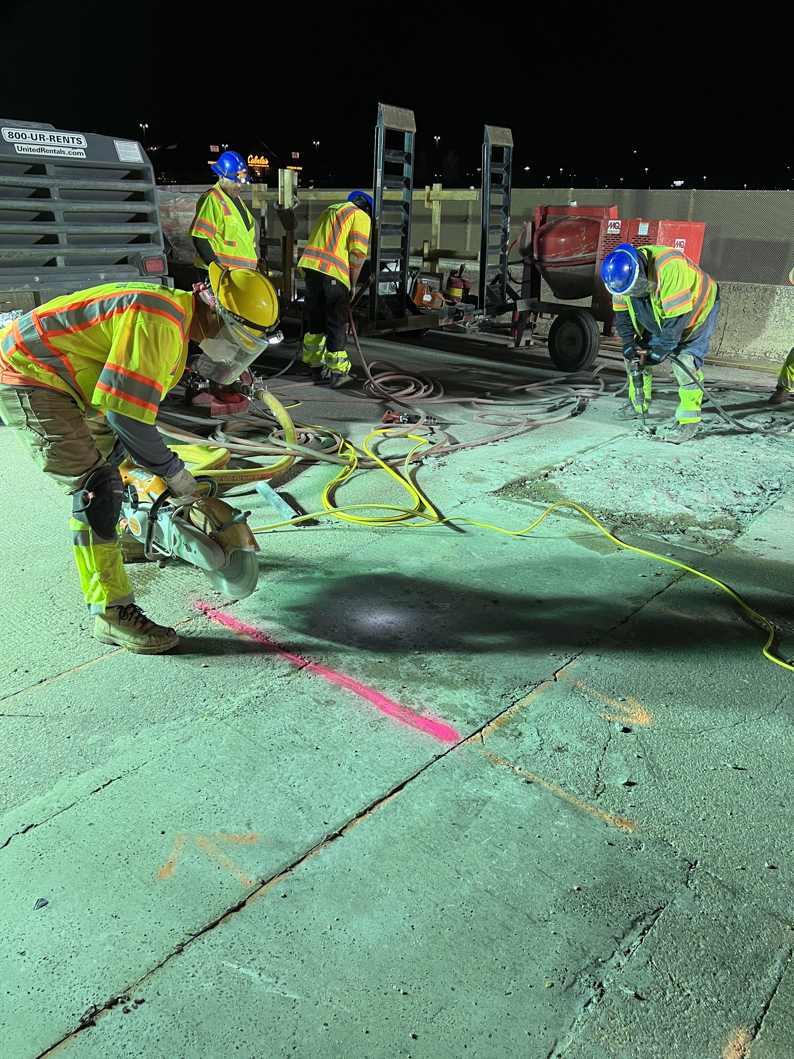 Nighttime concrete slab replacement operations in progress with workers detail image