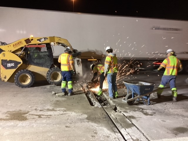 Members of the project team doing a saw and seal to replace the westbound I-70 bridge expansion joint devices. detail image