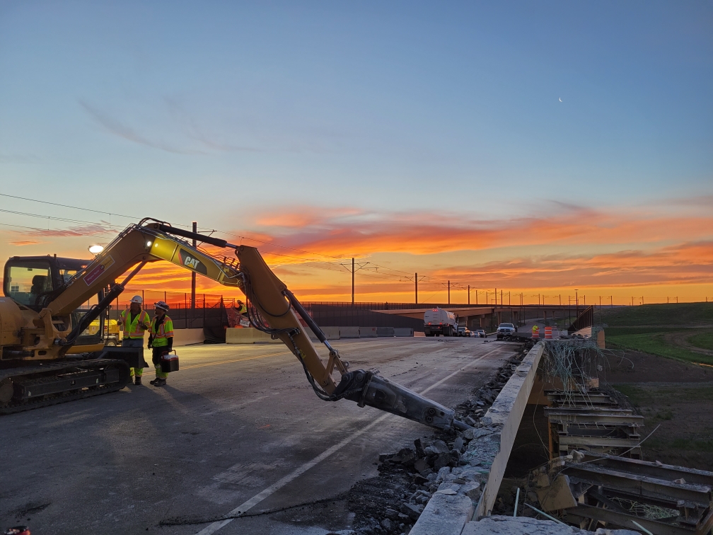 Sky Ridge bridge workers at sunset detail image